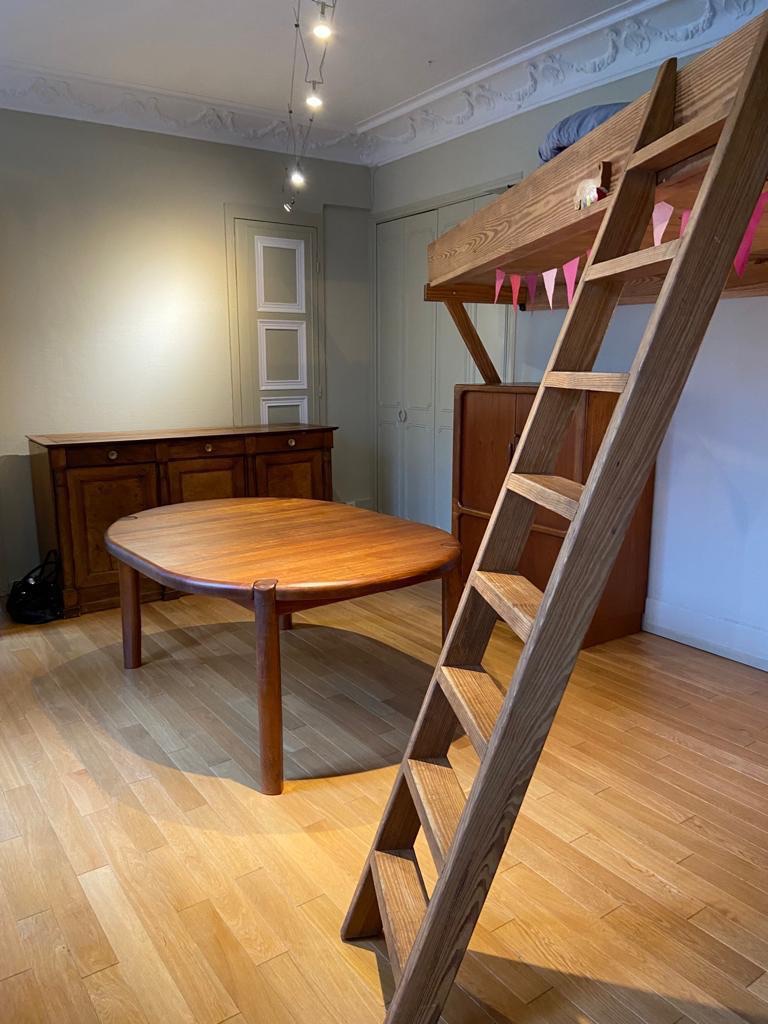 Perspective du salon avec armoire ancienne et porte moulurée